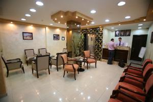 a man standing at the counter of a salon at Cedar Hotel in Aqaba