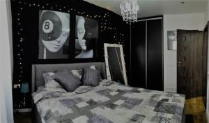 a bedroom with a bed with black and white posters at Casa Mia - Modern Luxury Apartament in Bucharest