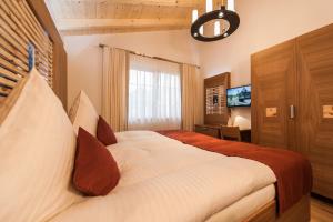 a bedroom with a large bed and a television at Chalet Oberstdorf in Oberstdorf