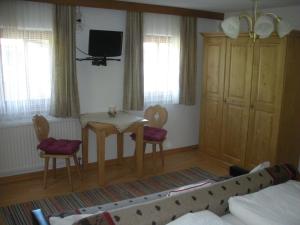 a living room with a table and two chairs at Riedlhof in Kössen