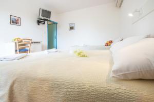 Tempat tidur dalam kamar di Pansion Oliva