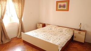 Postel nebo postele na pokoji v ubytování Apartmani Kaštelan