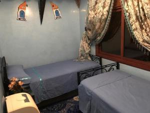 Rúm í herbergi á Riad Dar Mesouda