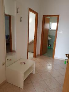 a living room with a white table and a mirror at Apartmani Sanja in Vrsi +71 photos