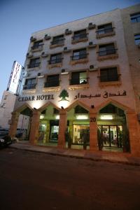 a building with a sign on the front of it at Cedar Hotel in Aqaba