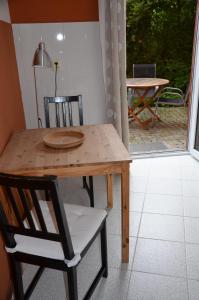 a wooden table and a chair with a table and a table and a patio at Apartmán Srdce Vltavy in Horní Planá