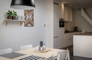 a kitchen and dining room with a table and chairs at Huize Sophia in Bruges