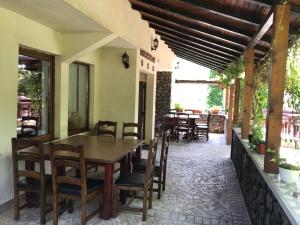 a dining room with a table and chairs at Pensiunea Trei Ponei in Corbeni