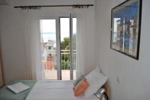 Postel nebo postele na pokoji v ubytování Apartmani Dalmadino