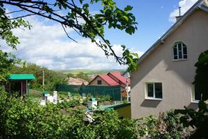 a view of a house with a garden in the foreground at Casa Bella Turda in Turda