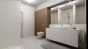 a bathroom with a sink and a toilet and a mirror at METRAK Apartamenty Darlowo in Darłowo +12 photos