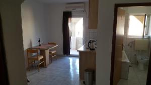 a kitchen with a table and a sink and a table and a tablektop at Apartman Luka in Vodice +27 photos