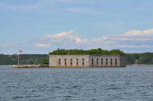 a large brick building in the middle of a body of water at The 8th Maine Regiment Lodge and Museum in Peaks Island