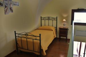 a bedroom with a bed and a table with a lamp at La Stella di Keplero in Cannole