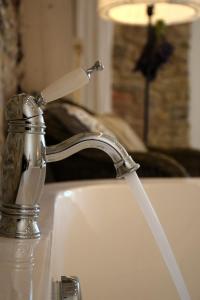 a water faucet on a kitchen sink at Sárffy House in Dörgicse