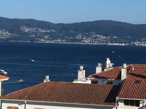 a view of the water and roofs of buildings at Playa Silgar en Galicia in Sanxenxo