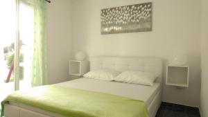 Postel nebo postele na pokoji v ubytování Apartmani Kaštelan