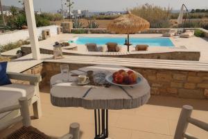 a bowl of fruit on a table next to a pool at Villa Mozaik in Plaka