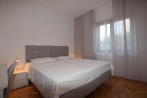 Postel nebo postele na pokoji v ubytování Apartments Pavić Valbandon