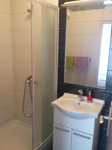 a bathroom with a sink and a shower at Apartments Katica in Rab
