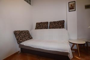 a small bed in a room with a table at Apartments Pavić Valbandon in Fažana