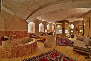 a large bathroom with a tub in a room at Eyes Of Cappadocia Cave Hotel in Uchisar