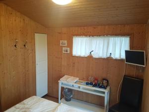 1 dormitorio con escritorio, 1 cama y ventana en Keldunes en Garður