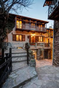 a large stone house with a balcony on top of it at Armona in Susa