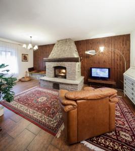 a living room with a stone fireplace and a couch at Armona in Susa