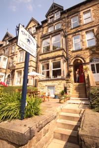 a street sign in front of a large building at The Dales in Harrogate