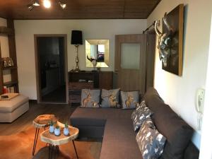 a living room with a couch and a table at Wachtelhof Apartment in Maria Alm am Steinernen Meer