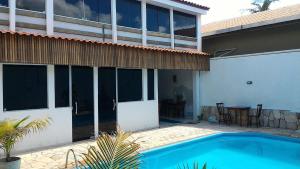 a house with a swimming pool in front of a house at Pousada Boa Vida in Maceió