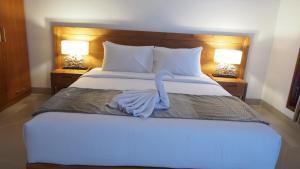 Postel nebo postele na pokoji v ubytování Kakol Homestay