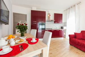 a kitchen and dining room with a table and a red couch at Bongiorno Home Private Free Parking Venice 10' in Marghera