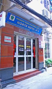 a restaurant with a sign on the front of a building at North Hostel N.2 in Hanoi