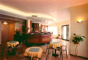 a restaurant with tables and chairs and a bar at Hotel Ristorante Pedrocchi in San Giorgio di Perlena