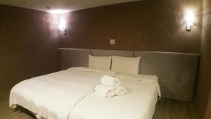 Postel nebo postele na pokoji v ubytování Walker Hotel - Zhengyi