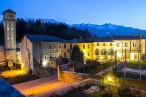 a view of a town at night with a clock tower at Maurice des Alpes in Teglio
