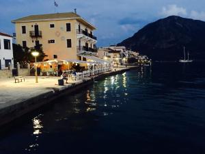 a building on the side of a body of water at MK Glaros in Mitika