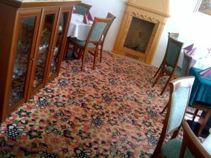 a room with a table and chairs and a rug at Hotel Line in Litvínov