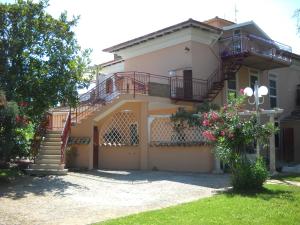 a house with a staircase and a balcony at Villa Giove in Terracina