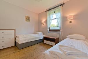 Ein Bett oder Betten in einem Zimmer der Unterkunft Imperial Apartments - Sopocka Przystań