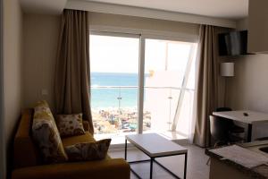 a living room with a couch and a view of the ocean at Apartamentos Casa Florido in Torremolinos