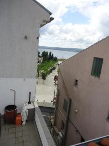 a view of a balcony of a building with a street at Apartments Popov in Crikvenica
