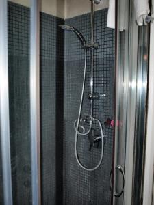 a shower in a bathroom with a glass door at Casa Tua a Piazza del Popolo in Rome