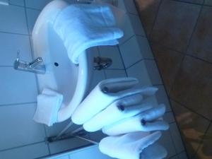 a bathroom with a sink with white towels on it at Haus Fernsicht in Husum