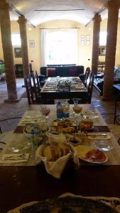 a long table with plates of food on it at B&B La Palazza in Russi