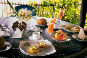 a table with plates of food and drinks on it at Satin Doll in Unawatuna +45 photos
