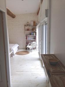 a living room with a wooden floor and a table at La Mazzerinière in Saint-Sylvestre +25 photos