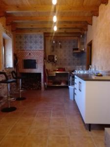 a large room with a kitchen with a counter top at Rural Las Campanas in Torremocha del Pinar